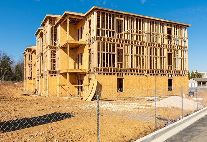 a temporary chain link fence winding around a job site, outlining the project's progress in Rolling Meadows, IL